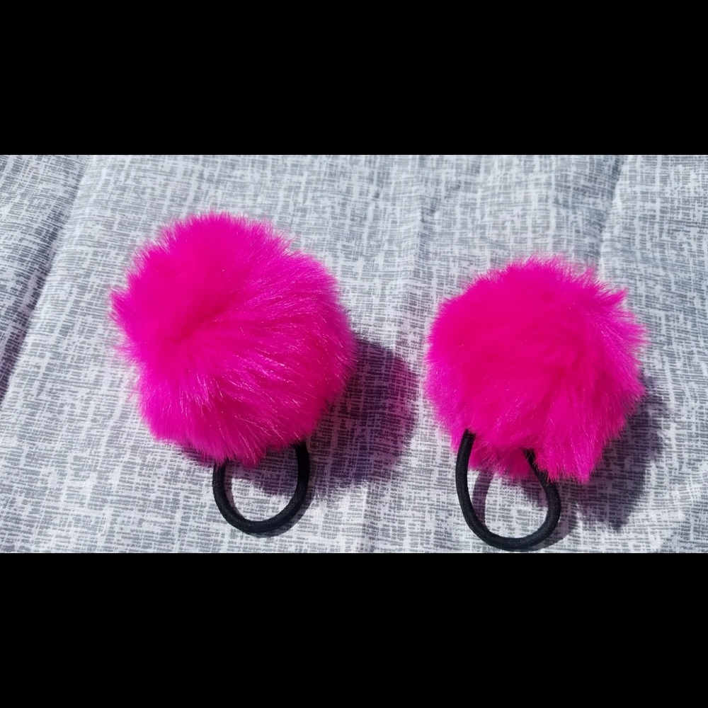 Pair of pink puff ball hair bands